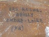 a piece of bread with writing on it sitting on a counter