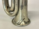 a silver vase with a handle on a white table