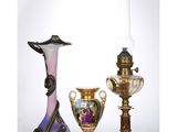 three vases and a lamp on a table