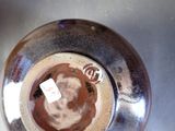 a close up of a vase with a tag on it