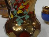 three different vases sitting on a table with a white background
