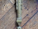 a clock that is on the wall on a wooden floor