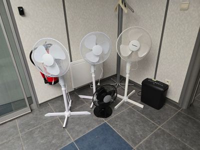 three fans that are sitting on the floor next to each other