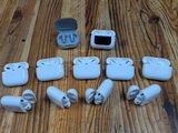 a lot of white airpods sitting on a wooden table