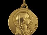 an image of a gold medal with a woman ' s face on it