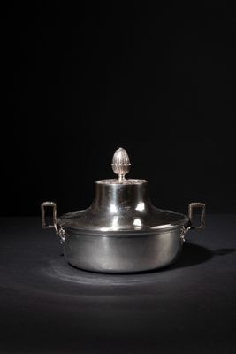 an image of a silver pot sitting on top of a black table