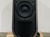 a black speaker sitting on top of a wooden pallet