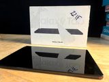 a black tablet computer sitting on top of a wooden table
