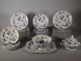 a lot of plates and bowls that are sitting on a table