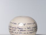 an image of a white vase with writing on it