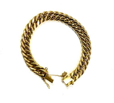 a close up of a gold chain bracelet on a white background