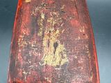 an old wooden box with a rusted surface on a table