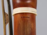 a close up of a wooden object with a white band on it