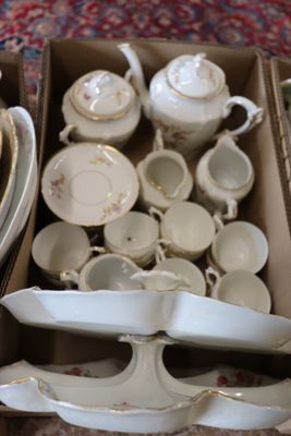 a box full of dishes and cups on the floor