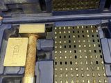 a tool in a blue case with a hammer inside of it