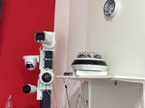 a picture of a room with a red wall and a television