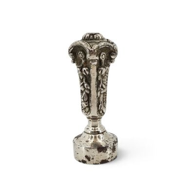 an image of a silver vase sitting on top of a white surface