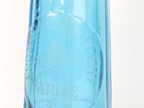 a blue glass bottle with a black top