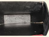 a close up of a piece of metal with a piece of wood sticking out of it