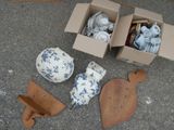 a box of tea cups and other items sitting on the ground