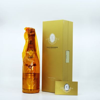 a bottle of champagne sitting next to a gold box