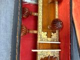 a wooden grandfather clock sitting in a case on the floor