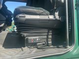 a suitcase in the back of a truck with the door open