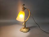 a lamp that is sitting on a table next to a wall
