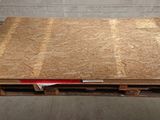 a wooden pallet with a sheet of plywood on it