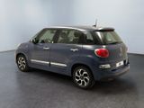the back of a small blue car parked in a room