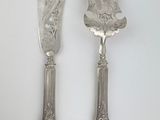two forks and a knife on a white table