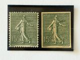 two stamps with a woman and a man on them on a wall