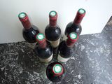 several bottles of wine are lined up on a counter top