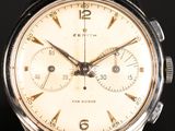 an image of a close up of a watch on a black surface