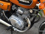 an orange motorcycle parked on the side of the road