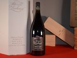 a bottle of wine sitting on a table next to a box