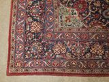 an oriental rug on the floor with a cat laying on top of it