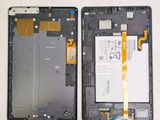 the back of a cell phone with a broken battery and a broken battery
