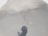 a close up of a silver plate with a black cat on it