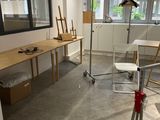 a room with a desk, chair, mirror, and other items in it