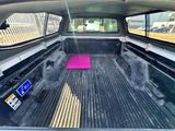 a pink mat in the back of a truck bed