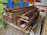 several pieces of wood are stacked on top of each other in a shed