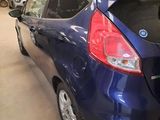 a blue car that is parked in a garage