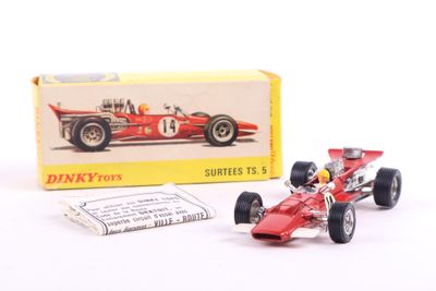 a red toy race car next to a box of matches