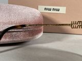 sunglasses in a pink velvet case with a gold rim and a black nosepiece