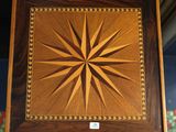 an image of a wooden box with a starburst design on it