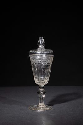 an old fashioned glass jar with a lid on a table
