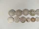 six different types of coins are arranged in a row on a table