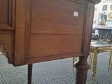 a wooden table with a drawer underneath it in a room