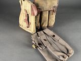 an old pair of canvas and leather bags sitting on a table